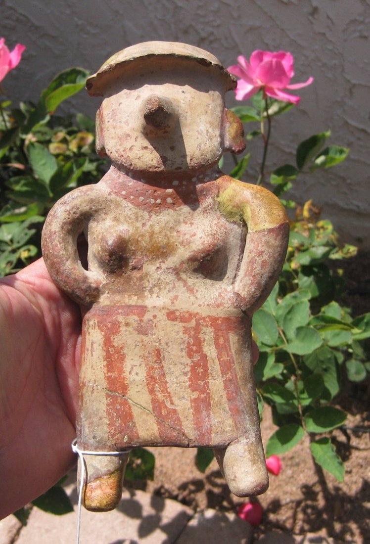 Pre-Columbian Figure: Painted female figure believed to be from Nayarit, Mexico. Circa 800 AD. Measures 9 by 5 inches. Shipping 15.00; Fair with some restoration. The restoration some of both ears, plaster on left shoulder