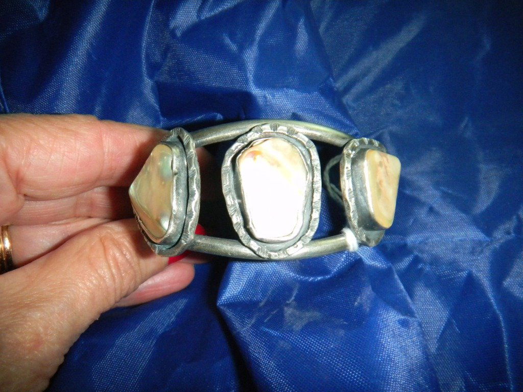 Bracelet: Silver and Abalone Bracelet. Bracelet has three abalone pieces and is Navajo from the 1960's. The bracelet is 2 and one half by two by four and one half inches. It is from Arizona and in good conditio
