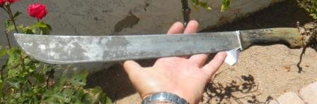 Machete: Machete has horn handle and carbon steel blade. It twenty by two inches. 1940. There is a signed mark but it is not clear enough to read