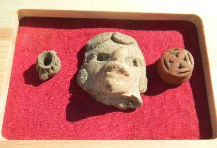 Pre-Columbian Collection: Pre-Columbian Collection consisting a small pot, pottery head and ceramic ear plub. The items measure from .5 to 2 inches. Shipping $14.50