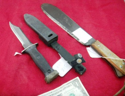 Two military knives: Two Military Knives, one is a U.S. MC Briddell Bolo Knife from World War II measures 16x3 inches; U.S. Navy MK 3 knife believed to be from the U.S. Seal Team. This knife measuring 11x2 inches. Conditi