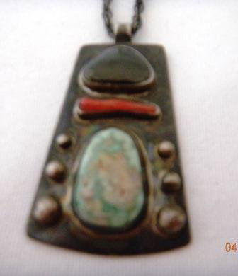 Old Pawn Sterling Silver Pendant with Turquoise, Coral: Sterling Silver Pendant with Turquoise, Coral and Obsidian Stones. This item is old pawn from the 1920's. The item measures 24 inches, the pendant is 1 3/4 by 1 1/4 inches. The item is shiny black fro