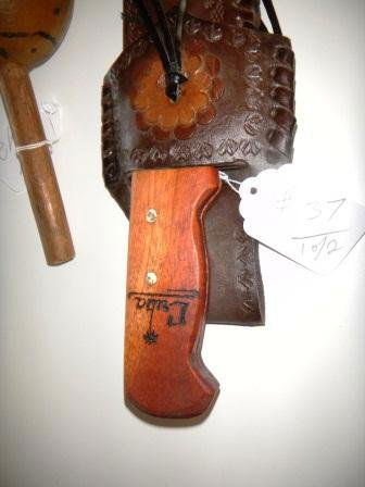 Cuba Memorabilia Machete and Gourd Rattle: Cuban Machete and Gourd Rattle. The Rattle states Cuba 1930, Welcome U.S.N. The Machete is steel and wood with "Cuba" on the handle and "Cuba" on the Leather Scabbard. Everything is in good condition.