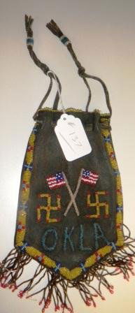 Beaded Leather Bag: Beaded Leather Bag, dated 1927 on one side and has American Flags and the whirling logs. The bag also states OKLA for Oklahoma. The beads are glass and are in good condition. Item has red, yellow, blu