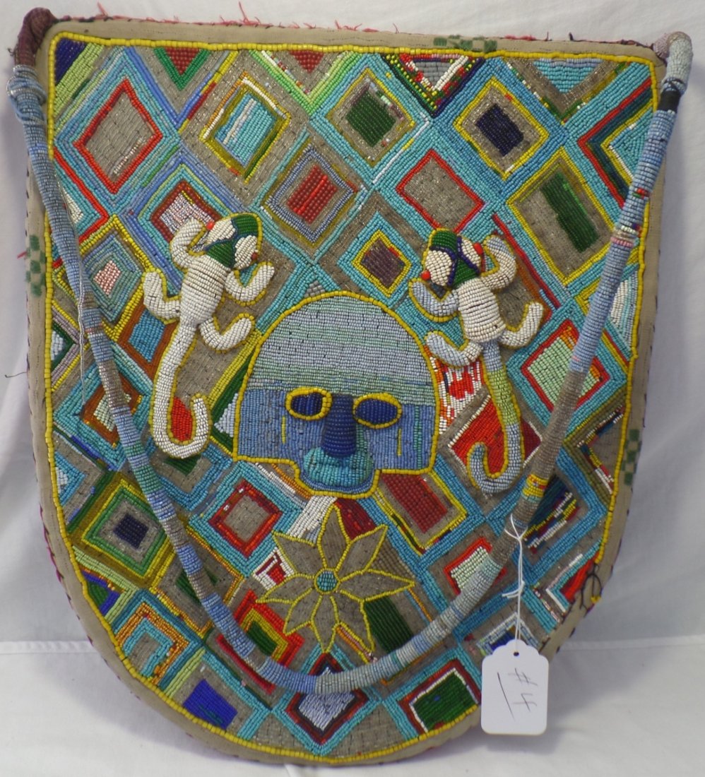 African Beaded Bag: African Beaded Bag of the Kuba Tribe. Bag measures 38.5" x 16". Bag has two ornately beaded lizard effigies as well as a flower, statue-like face, and multiple colors throughout. Bag opens up vertical
