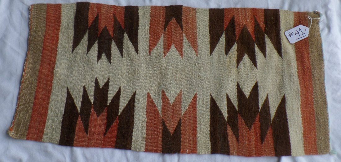 Navajo Gallup Throw Weaving: Navajo Gallup Throw Weaving from Gallup, New Mexico. Weaving measures 35" x 17.5". Colors include red, brown, beige, and light brown. Condition: Very Good. Shipping: $18.