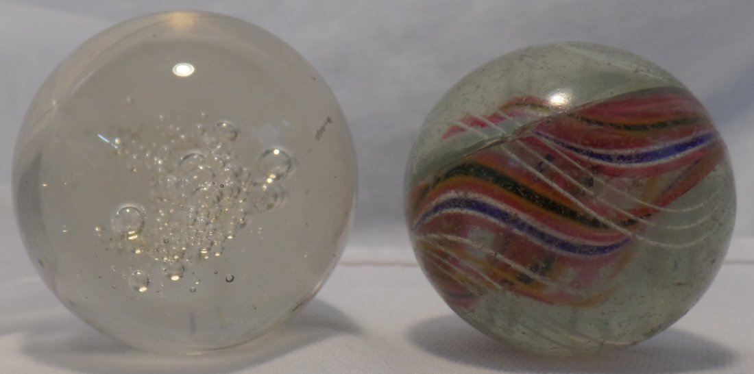 Two 2-Inch Vintage Marbles: Two 2-Inch Vintage Marbles. Circa 1860. Includes rare "candy cane" swirl marble, featuring white, blue, pink, orange, black, purple and green. 2nd marble is a clear marble with varying size bubbles. C