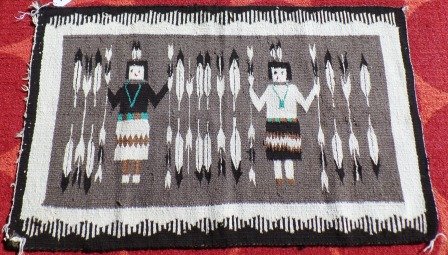 Navajo Rug: Navajo Rug. 26.5" x 42.5". Rug depicts 2 figures and arrows. Colors include gray, black, turquoise, brown and white. Condition: Good w/some minor stains. Shipping: $18