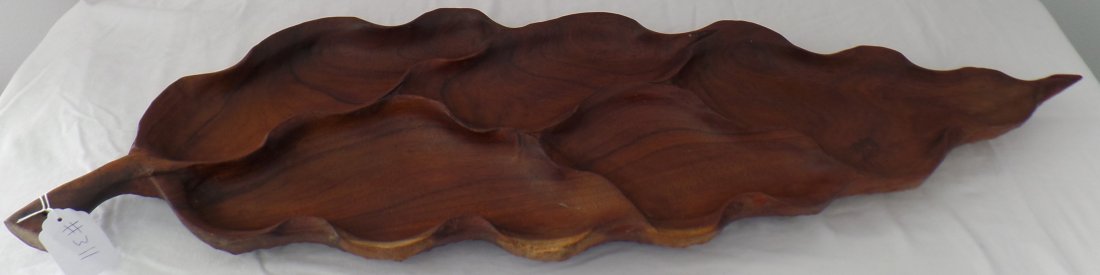 Polynesian Wood Feast Bowl: Polynesian Wood Feast Bowl. Item is handcarved wood and in the shape of a large leaf. Item measures approx. 41" long x 12.5" wide x 2" tall. Item weighs approx. 8.25 lbs. Intricate carving on undersid