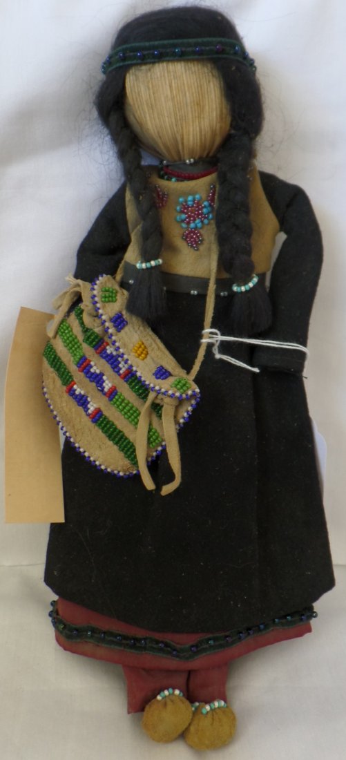 Corn Husk Iroquois Doll w/Beaded bag: Corn Husk Iroquois Doll w/Beaded Bag circa 1920. Measures 11" x 6" x 2" and is made of glass beads, corn husk, wool, deerhide, and silk under dress. Has no facial features and has beadwork on deerhide