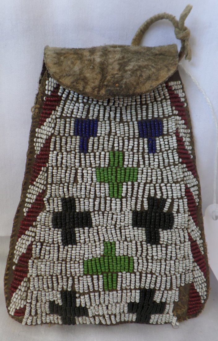 Apache Belt Bag: Apache Belt Bag circa 1880s. Made of harness leather and seed beads. Measures 6" x 4" x 3/4". From the White Mountain Apache tribe. Belt bag most likely for 45/70 ammo. Crosses design, white, black, b