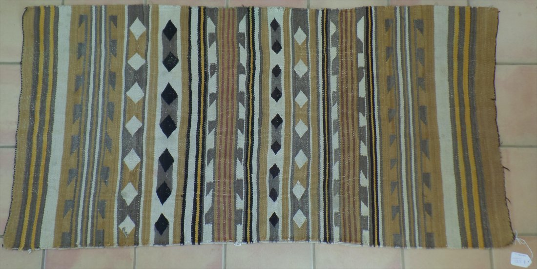 Navajo Weaving: Authentic Navajo Double Saddle weaving from the 1940's. This Navajo wide ruins pattern is well worn with edge damage. The wool weaving measures 36x72 inches. Helm Collection. Shipping $40.00