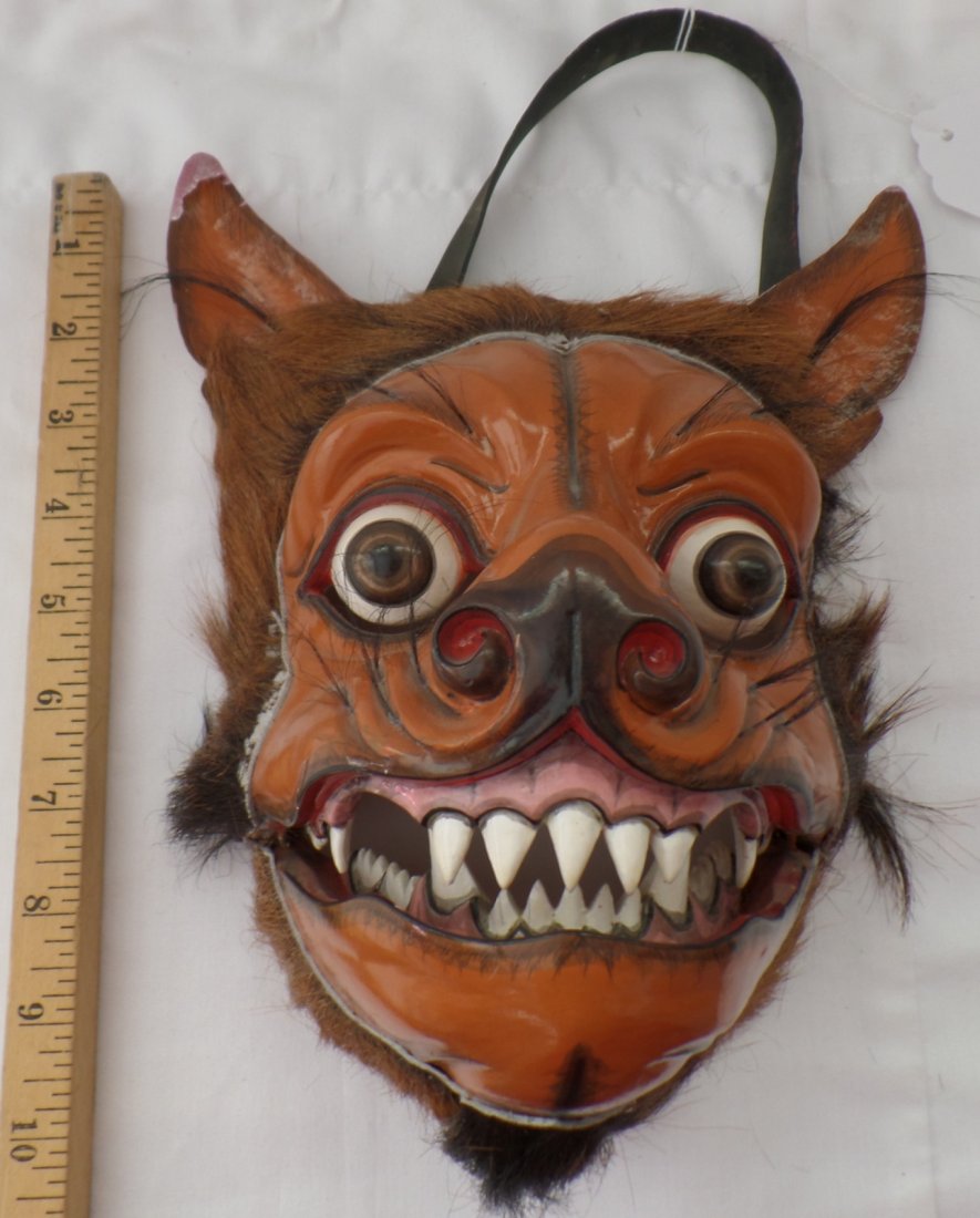 Fine Movable Wolf Mask: Check out this great wood, hide and plastic wolf mask from the 1970's. It is from Indonesia and signed Ykt Berati. There is paint chipping on ears. This mask has a movable jaw, good teeth and eyes. Th