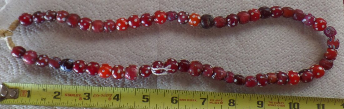Fancy Glass African Trade Beads: These 20th Century fancy glass African beads are from Nigeria. The beads are red with white round spots. There are minor defects as some of the beads are older than others. Shipping $16.00. Helm Colle