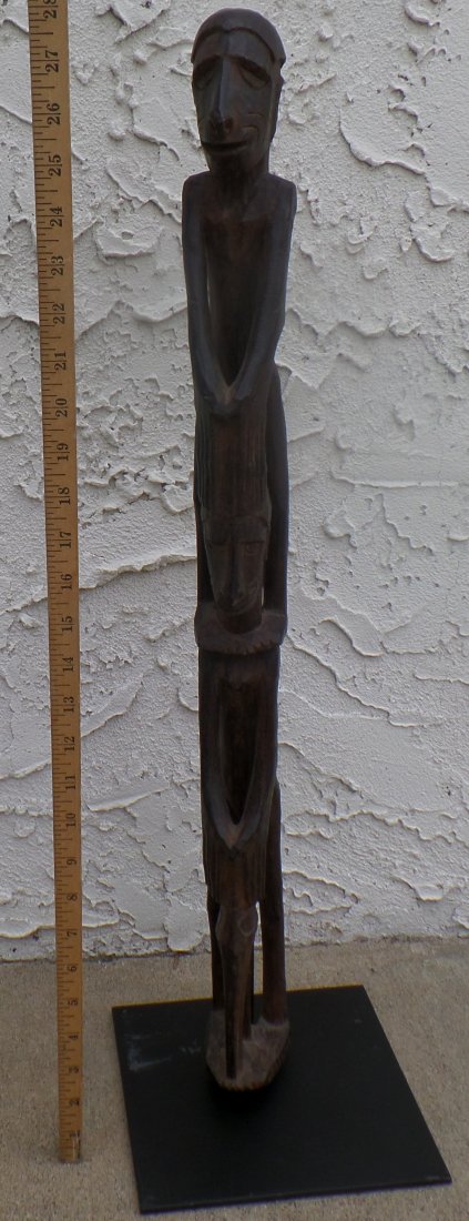 New Guinea Totem, with Custom Stand: This is a 1910 New Guinea Totem made from wood with a steel stand. This is from Sepic River Area. The item measures 27"x5"x2" and there are minor nicks and scratches. This is from a San Diego Estate. 