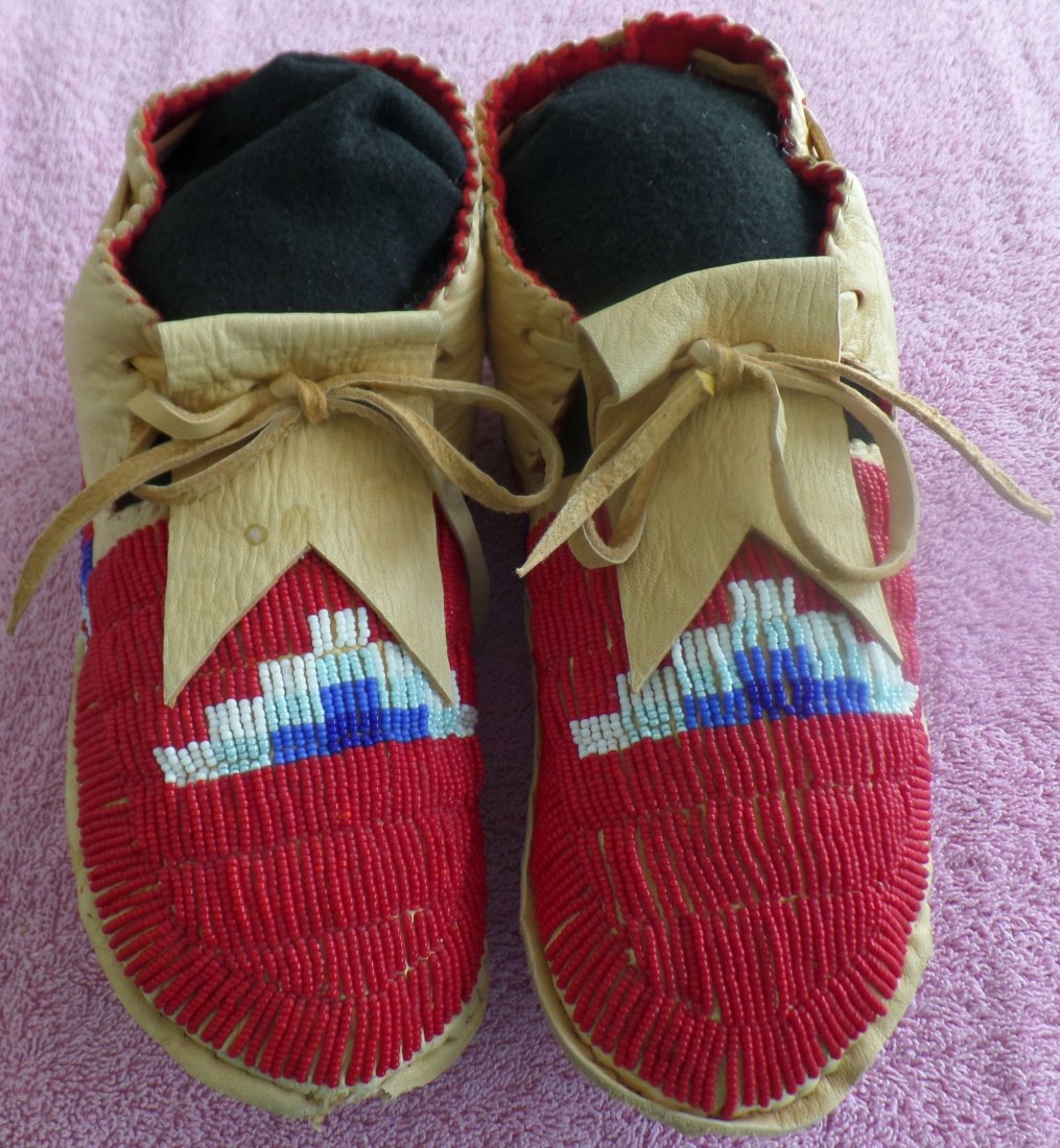Beaded Deerhide Moccasins: Nice 1950's Beaded Deerhide Moccasins. Very fine Deerhide and glass beads. These Sioux Moccasins have minor toe damage on right moccasin. There are minor stains. Nice Red, White and Blue Beads. Becaus