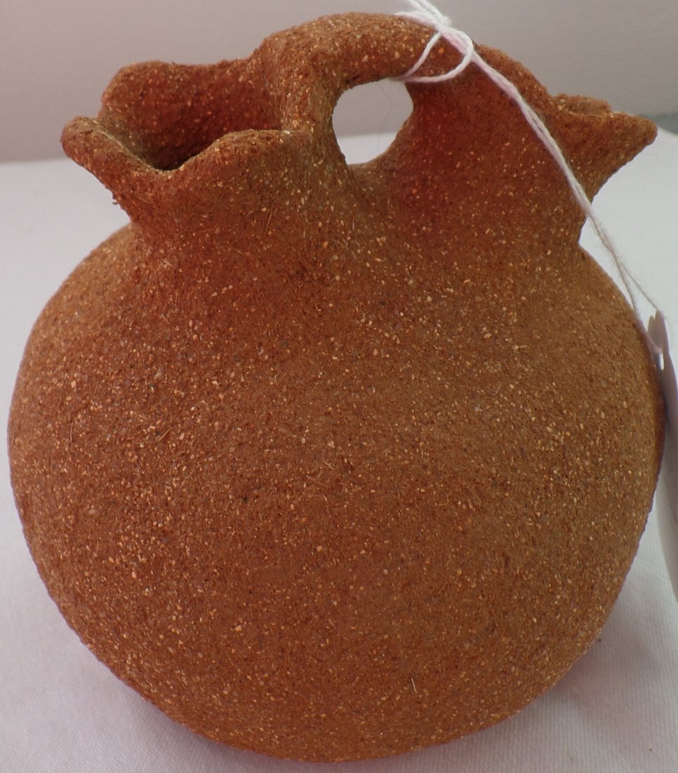California Wedding Jar: 1900's San Diego County, California, clay 5 x 5 x 5 inches. The tribal affiliation is Cahuilla. It has a double neck. The wedding jar appears to be weathered almost like being sand blasted. Requires d