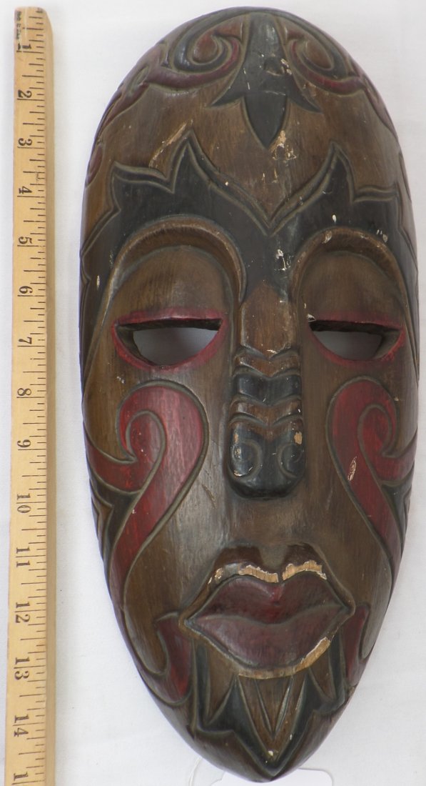 Indonesian Mask: Nice carved and painted design on this 1940's Indonesian Mask measuring 15 1/2 x 7 1/2 inches. This is possibly Dayak. Good collectors item. Condition: Some nicks and scuffs but overall good condition
