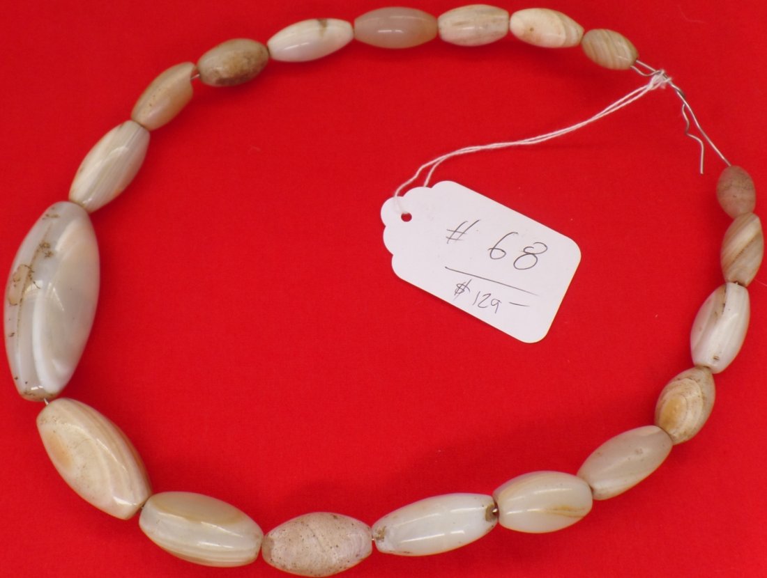 Archaeological Agate Beads: Prehistoric agate and carnelian beads from Southern Kenya. There are nicks and scratches and chips. The bead strand is 20 inches and beads measure from 1/2 to 2 1/2 inches. Shipping $13.