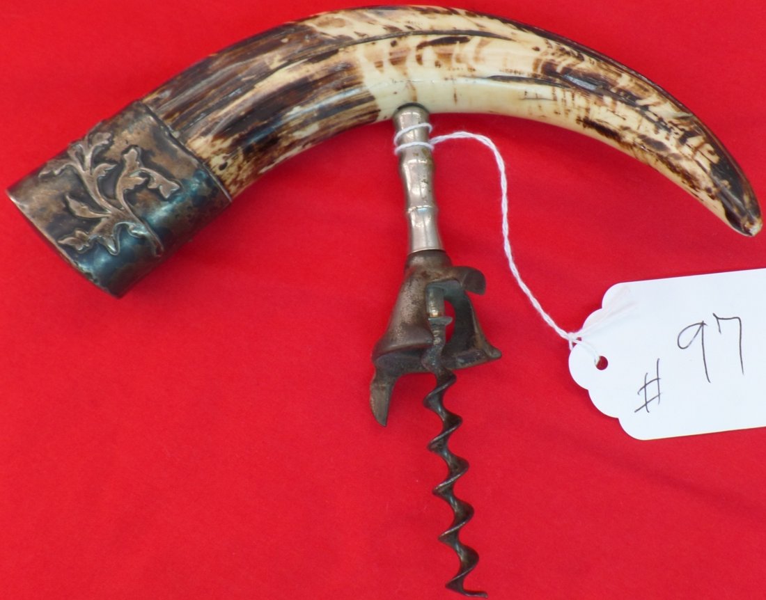 Boar's Tooth Cork Screw: This 1890 Indonesia Boar's Tooth Cork Screw has a sterling cap and is made from steel and tooth. It is tarnished and stained and measures 7 x 6 inches. Shipping $15.00