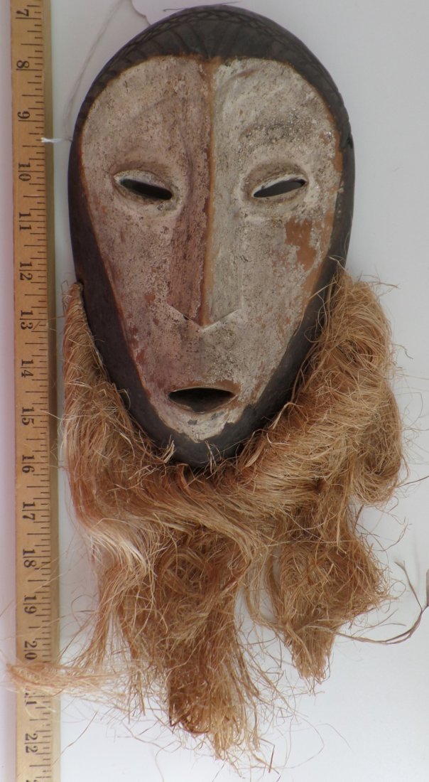 Antique African Wood Mask: Antique African Wood Mask. Circa 1900. Made of wood, some paint and fiber. Overall length is 15" x 6". Lega Tribe. Investment quality piece. Condition: Some paint missing, some minor scuffs and scrape