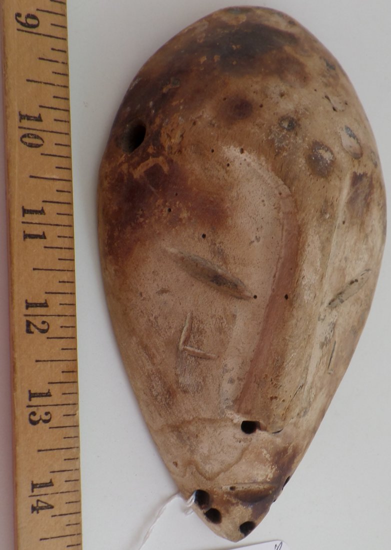 Antique African Passport Wood Mask: Antique African Passport Wood Mask. Circa 1900. Made of wood. Measures 7" x 4". Lega tribe. Condition: Stains, scuffs and scrapes from use, see images. Shipping: $16.