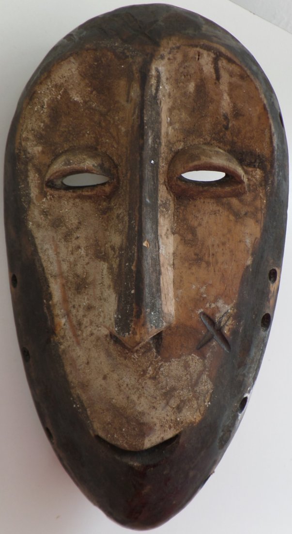 Antique African Handheld Wood Mask: Antique African Handheld Wood Mask. Made of wood and measuring 8.5" x 4.5" x 2". Lega tribe. Unusual type of mask. Held in hand by handle in back while dancing. Condition: Minor scuffs and scrapes, ap