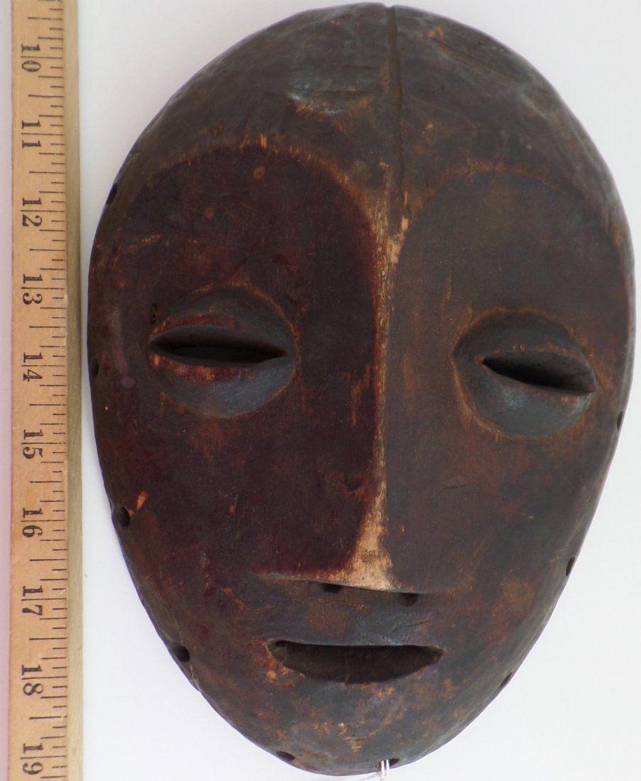 Antique African Wood Mask: Antique African Wood Mask made circa 1900s. The mask measures 10.5" x 7.5" and is made of wood and fiber. Lega tribe. Condition: Fiber missing, heavy patina. Shipping: $16.