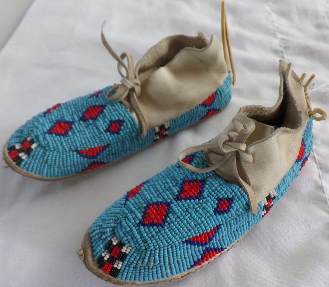 Authentic Cheyenne Childs Moccasins: 1940s Authentic Cheyenne Childs Moccasins made of glass beads and rawhide soles. Measures 8" x 2.5" x 2". Cheyenne. Condition: Good, see images. Shipping: $18.