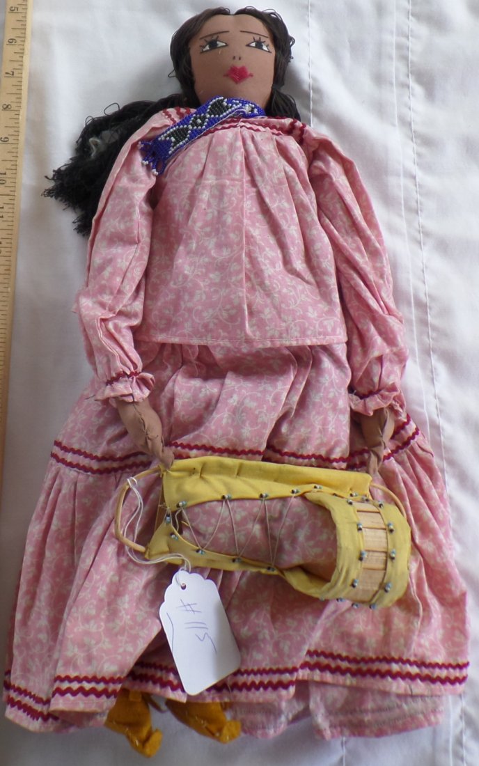 Authentic Large Apache Doll: 1940s Authentic Large Apache Doll measures 19" x 16" and made of cloth and beads. Apache. Beaded necklace and cradleboard w/doll. Condition: Good. Shipping: $20.00