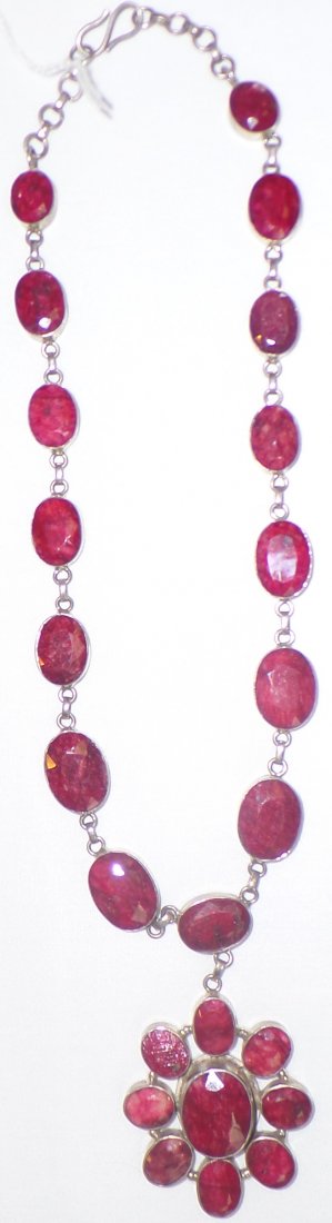 Authentic Ruby Necklace: 1960s Authentic Ruby Necklace made of sterling silver and rubies. 24 nicely faceted ruby stones. Necklace measures approx. 98.25 including stone weight. Condition: Fine, see images. Shipping: $25.