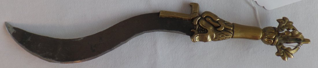 Effigy Tibetan Ceremonial Knife: The blade is the monster's tongue on this Tibetan Ceremonial Knife. This Brass and Steel 1900's knife is very sharp and measures 14 x 2 inches. There is a very good patina, but the knife has been shar