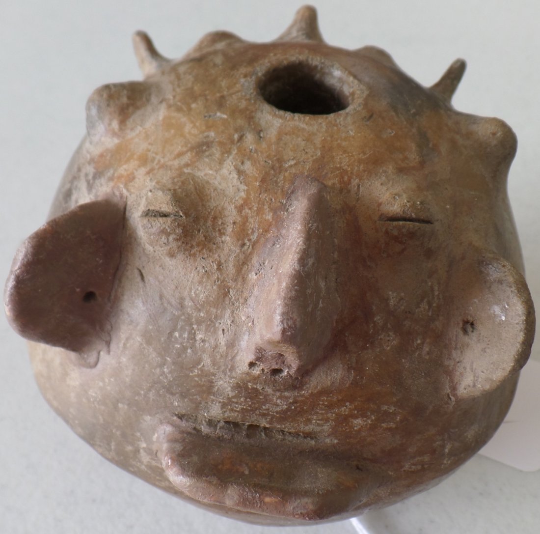 Pre-Columbian Effigy Pot: This item is made from Clay and measures 4 1/2 x 4 1/2 x 5 inches. It is from Chile, South American. There is restoration on chin and knob on face. This is a rare pot. Shipping $18.00