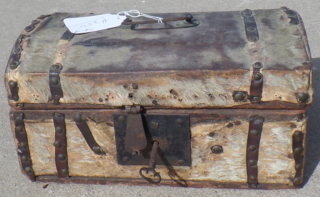 Small Wood Wagon Train Trunk: This is a great old relic which measures 12x7x6 inches. It is from the 1840-1850's and is made from wood, iron, deerhide, brass and paper. This item is possibly English. It has severe wear, has key bu