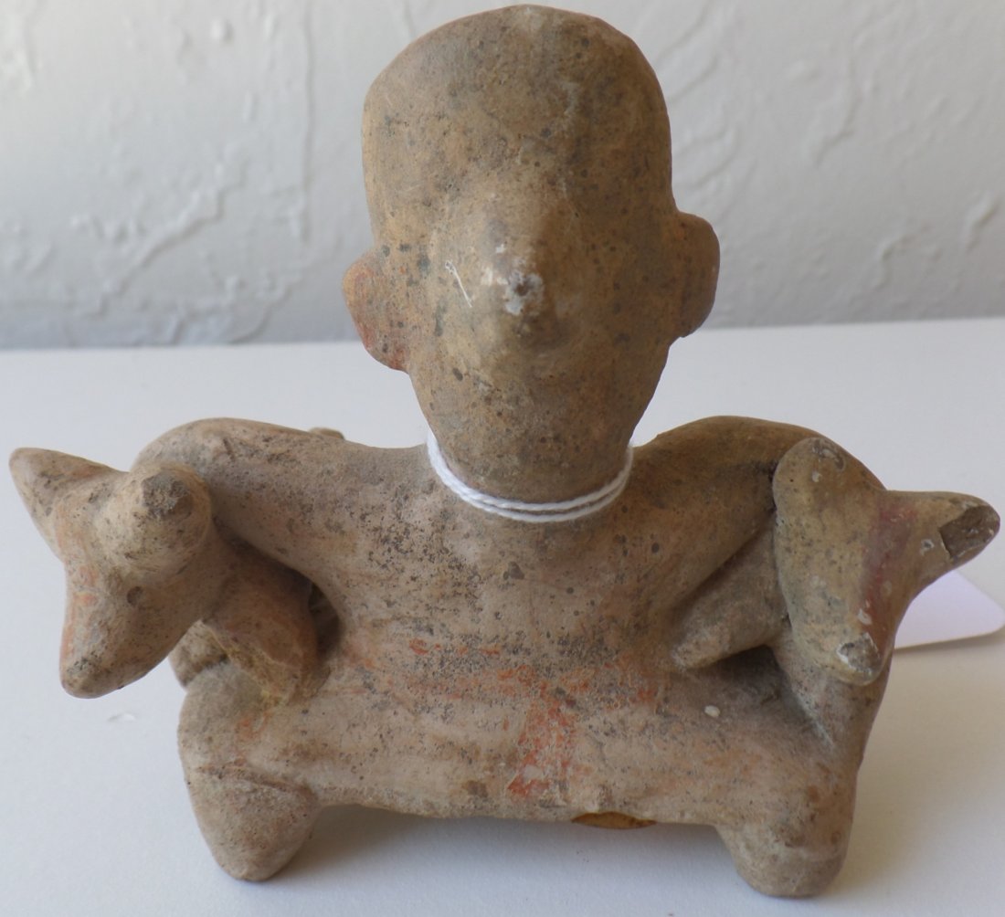 Pre-Columbian Man with two dogs: This Pre-Columbian piece is from Colima, Mexico and was part of a private collection from Alpine, California. The clay item measures 4 x 3 x 2 inches and is in good condition. Shipping $20