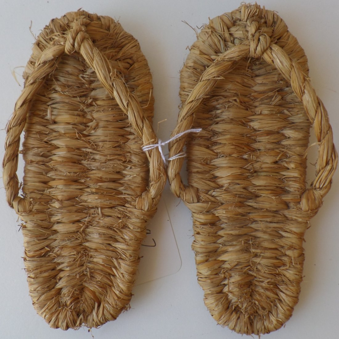 Pair of Fiber Sandals: Pueblo pair of fiber sandals made in the 1900's from Yucca. The sandals measure 8 x 3 inches and show some wear. Shipping $14.50