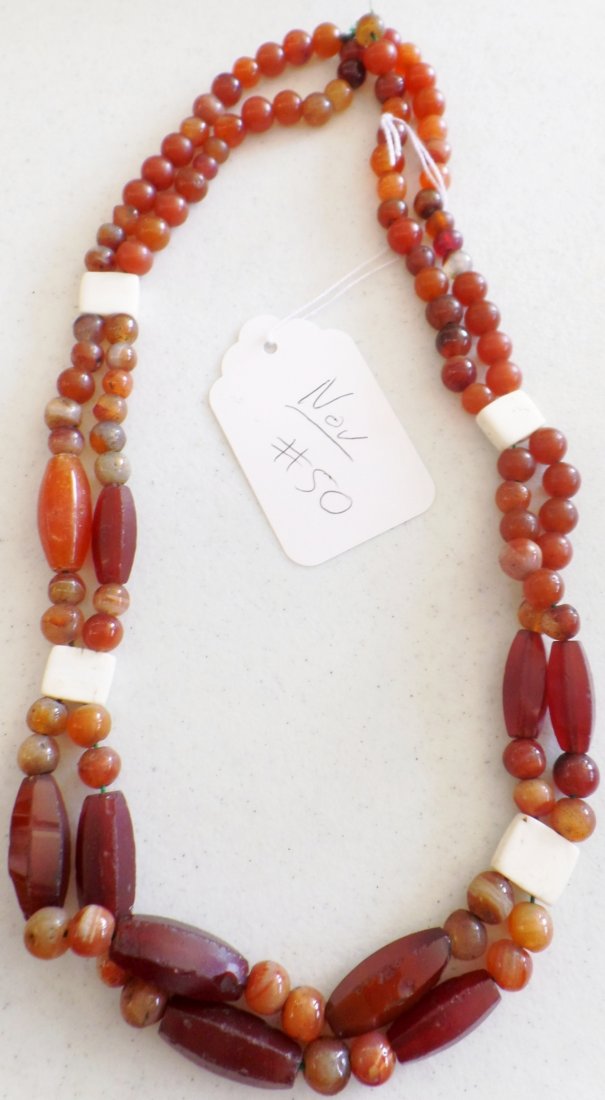Double Stranded Carnelian Bead Necklace w/Bone Spacers: Double Stranded Carnelian Bead Necklace w/Bone Spacers. C.1880's. Made of beads and bone. Necklace measures approx. 12" as worn. From North America. Condition: Some nicks and scratches, see images. Sh