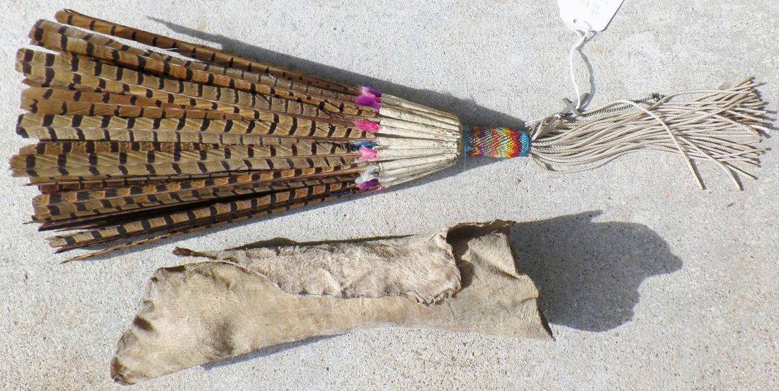 Navajo Peyote Dance Fan: Navajo Peyote Dance Fan Deerhide wrapped. This item is approximately 50 years old and is made of approximately 46 pheasant feathers with two inches of fine beadwork. The item measures approximately 20