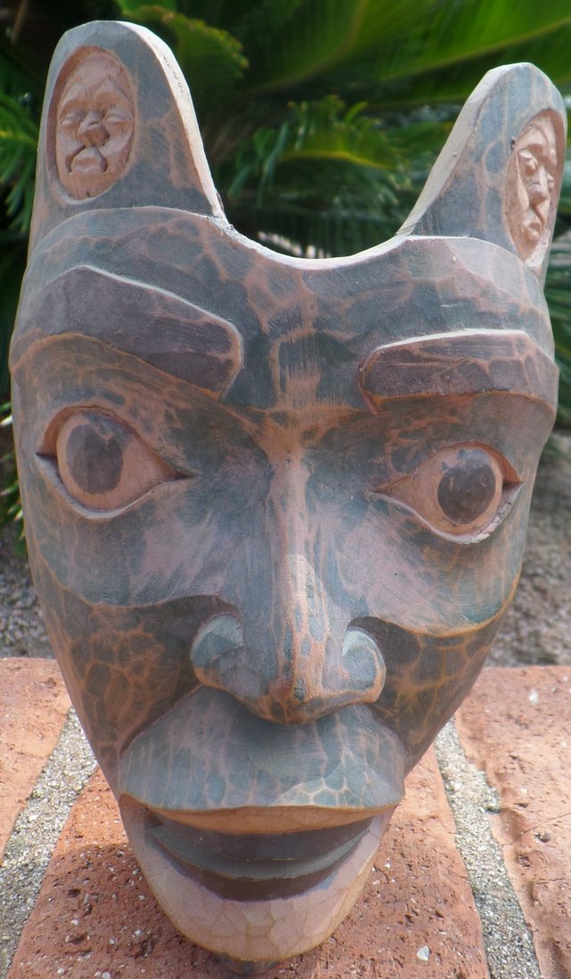 Northwest Coast Style Mask: Northwest Coast Style wood mask from approximately 1950's. The item is made from wood and paint and measures 7 1/2 x 4 x 4 inches. This is a human face mask painted with drab green and black paint. So