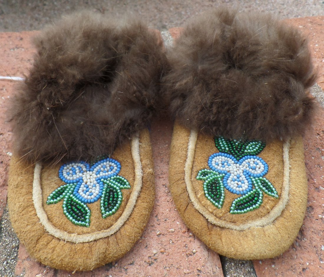 Pair of Beaded Moccasins: Pair of Beaded Moccasins, circa 1920s. Made of glass beads, fur and moosehide and cloth. Each mocc. measures approx. 7.5" x 4" x 2". Nice pair of beaded child's moccs. Probably Cree Indian, Canada. Co