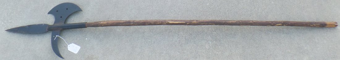 Antique Spanish Pole Arm: Antique Spanish Pole Arm, circa late 1800s. Made of wood and an iron head. Measures 78" x 15" x 1". Spanish, New Spain. This has a wood carved handle with cutouts on the iron blade. Condition: Old cra