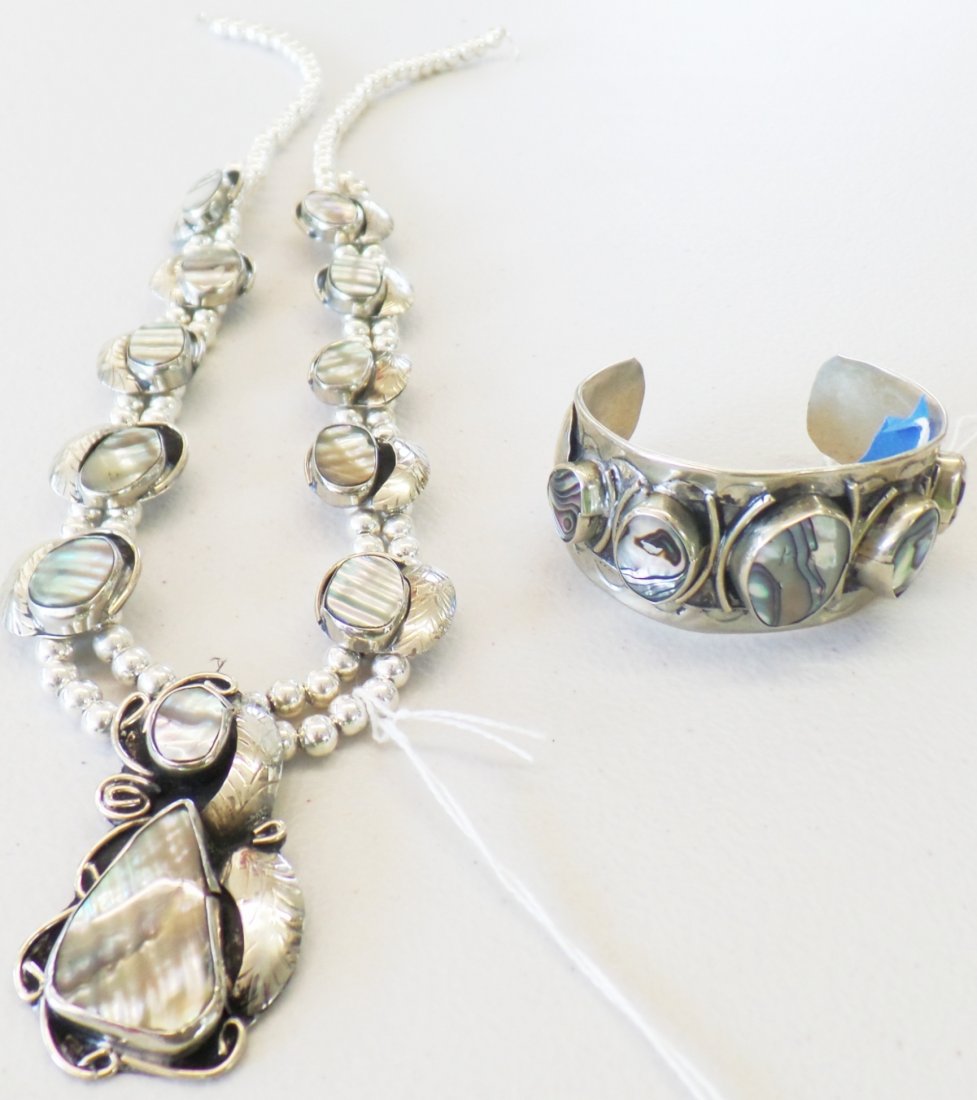 Mexican Sterling Silver Cuff w/Squash Blossom Necklace: Mexican Sterling Silver Cuff w/Squash Blossom Necklace. Cuff appears to be around 1960s. Made of sterling silver and abalone. Inside measurement on cuff is 6", outside is 7.25", dimensions are 3" x 2.