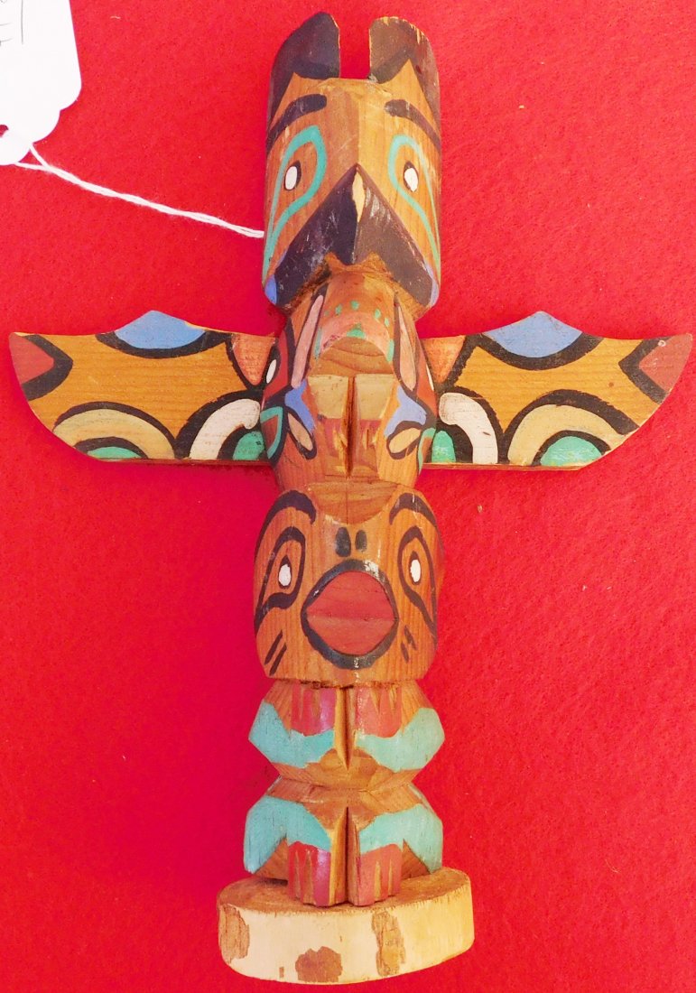 Small Northwest Coast Totem: Northwest Coast Small totem pole, measuring 8 1/2 x 7 x 3 inches. This item is made from cedar and paint. The item is signed. Condition: Worn with some minor paint loss. Shipping: $16.50