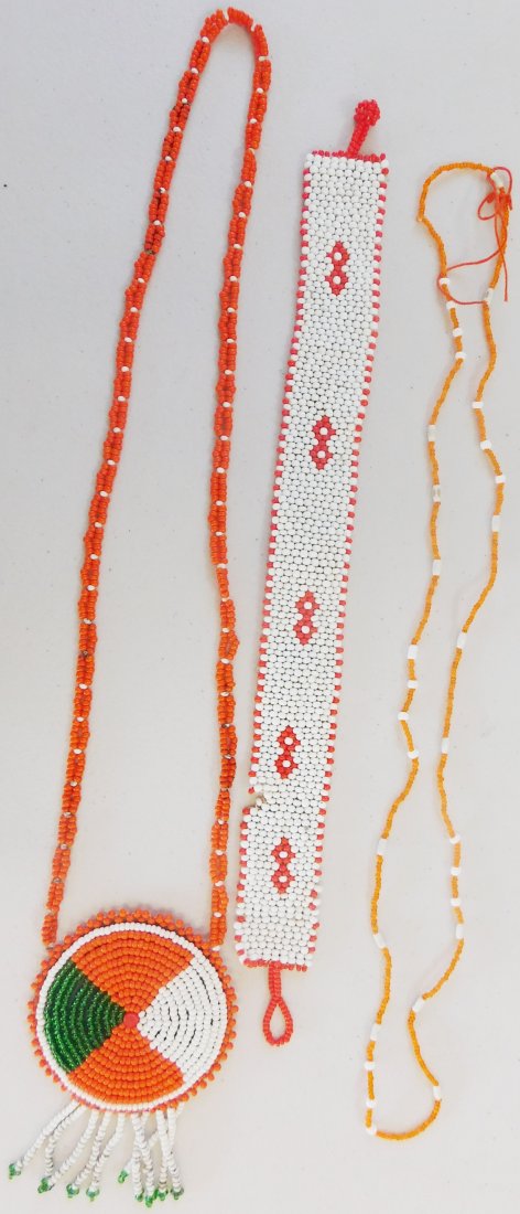 Fancy Beadwork Group: This group of beadwork includes a 16" long orange/white beaded necklace, a 12" x 1.25" red/white beaded strip with some bead loss, and an 18" long beaded necklace with 3" x 3" beaded pendant on leathe