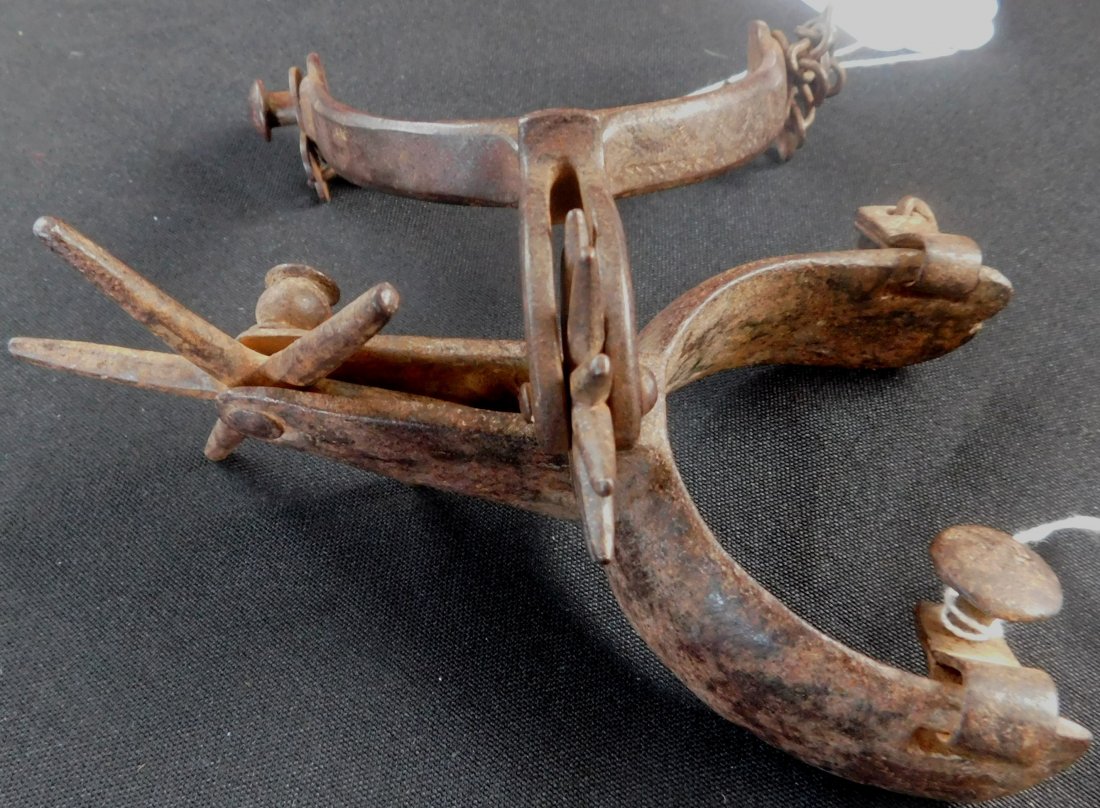 Two Antique Western Spurs: Two Antique Western Spurs, circa 1850s. Made of steel and measuring each about 6" x 4". From the American southwest. Smaller one is "STAR" brand while the larger one is older and is probably Mexican. 