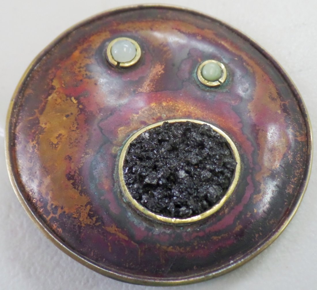 Old Mexican Copper Pin: Old Mexican Copper Pin, circa 1940s. Made of copper, ground black stone, and possibly 2 pearls. Item measures 2.5" x 2.5". This old Mexican pin is an open-mouth face, the pearl-like objects forming th