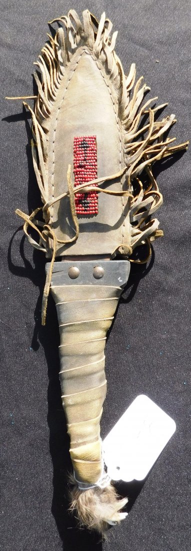 Plains Indian Dag Knife & Sheath: Plains Indian Dag Knife & Sheath, circa 1900. Made of rawhide, animal teeth, brass tacks, wood and carbon steel. Item measures overall 17" x 3" x 1". Sioux, from the Dakotas. Condition: Some dust, wea