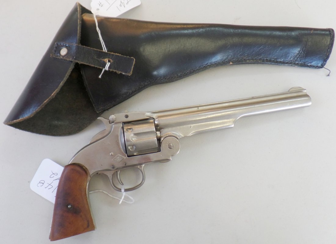 Break Top .45 Caliber Pistol and Holster (Copy): Break Top .45 Caliber Pistol and Holster (Copy), 20th century. The pistol measures 13 x 6 x 2 inches, and the holster measures 16 x 7 inches. The pistol is marked BXA 217. This is a single action (non