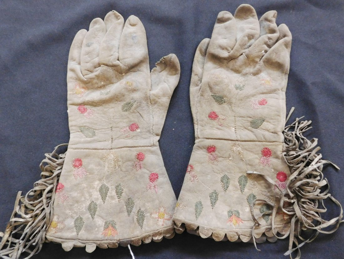 Antique Canadian Gloves: Antique Canadian Gloves, circa 1840s. Made of buffalo skin and wool embroidery. Items measure 11.5" x 7" x 1" each, Canadian Cree. Very old gloves and seldom seen. Condition: Worn, holes in thumbs, se