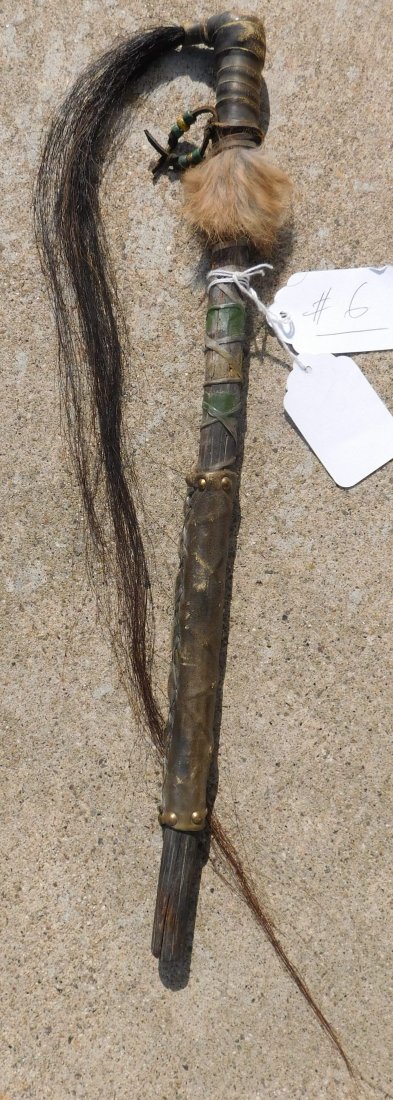 Plains Dance Wand: Plains Dance Wand, from about the mid-20th century. Wand measures 19 x 16 x 1 inches. Item is made of wood, horse hair, fur and tacks. Sioux, South Dakota. Condition: This item shows some wear because
